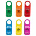 Six colorful hanging tags labeled 'BRICK THERAPY' with a brick icon and 'Session in progress' text, shown on a white background.